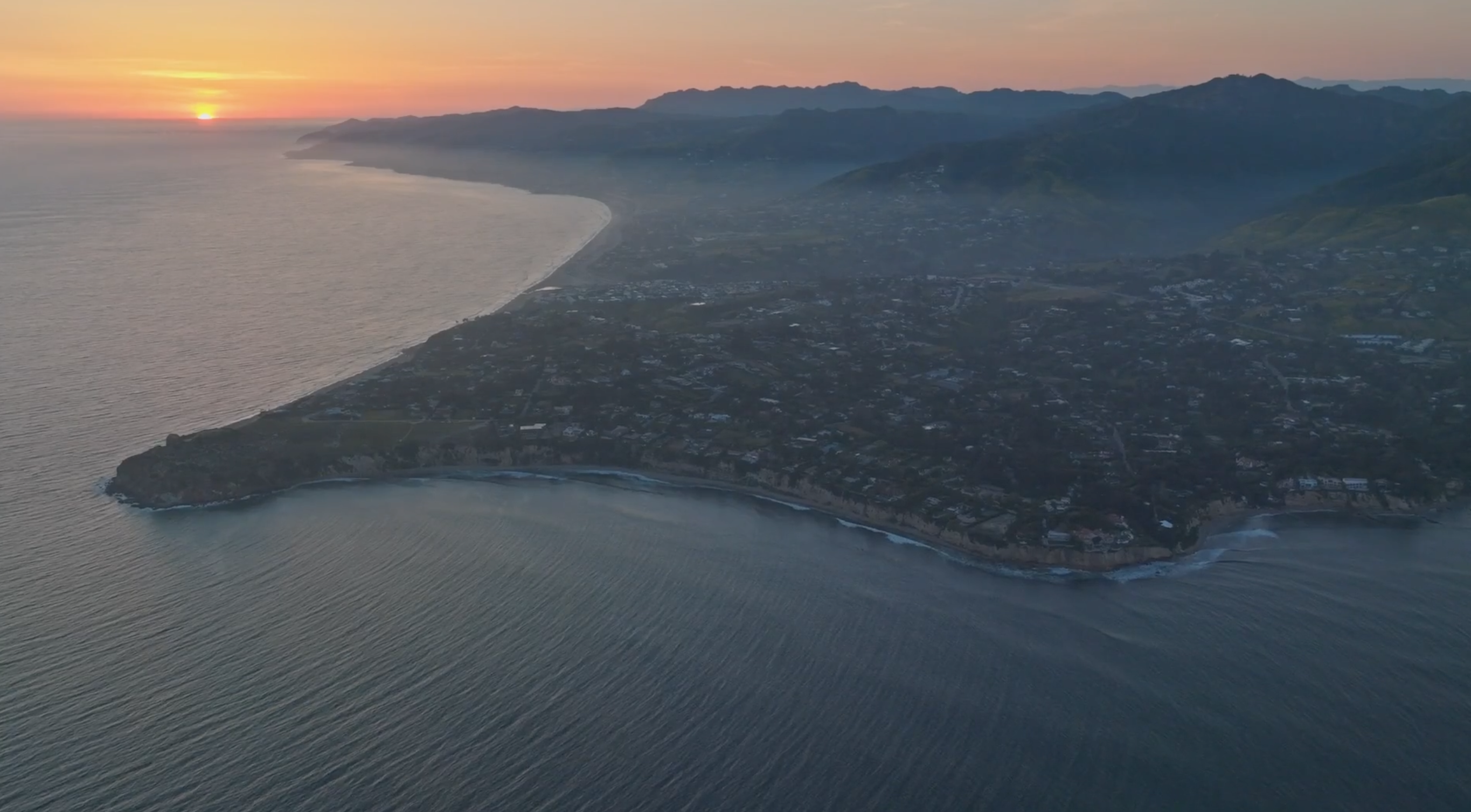 A bird's eye view of a sunset over a peninsula