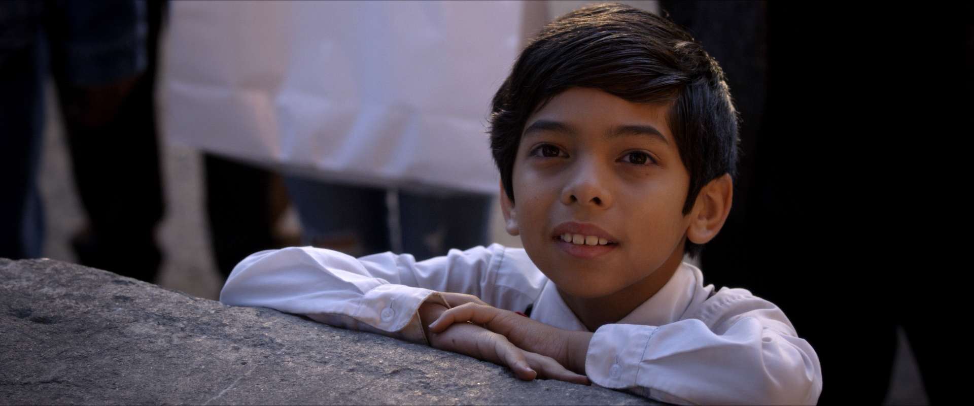 A child smiles from Believe
